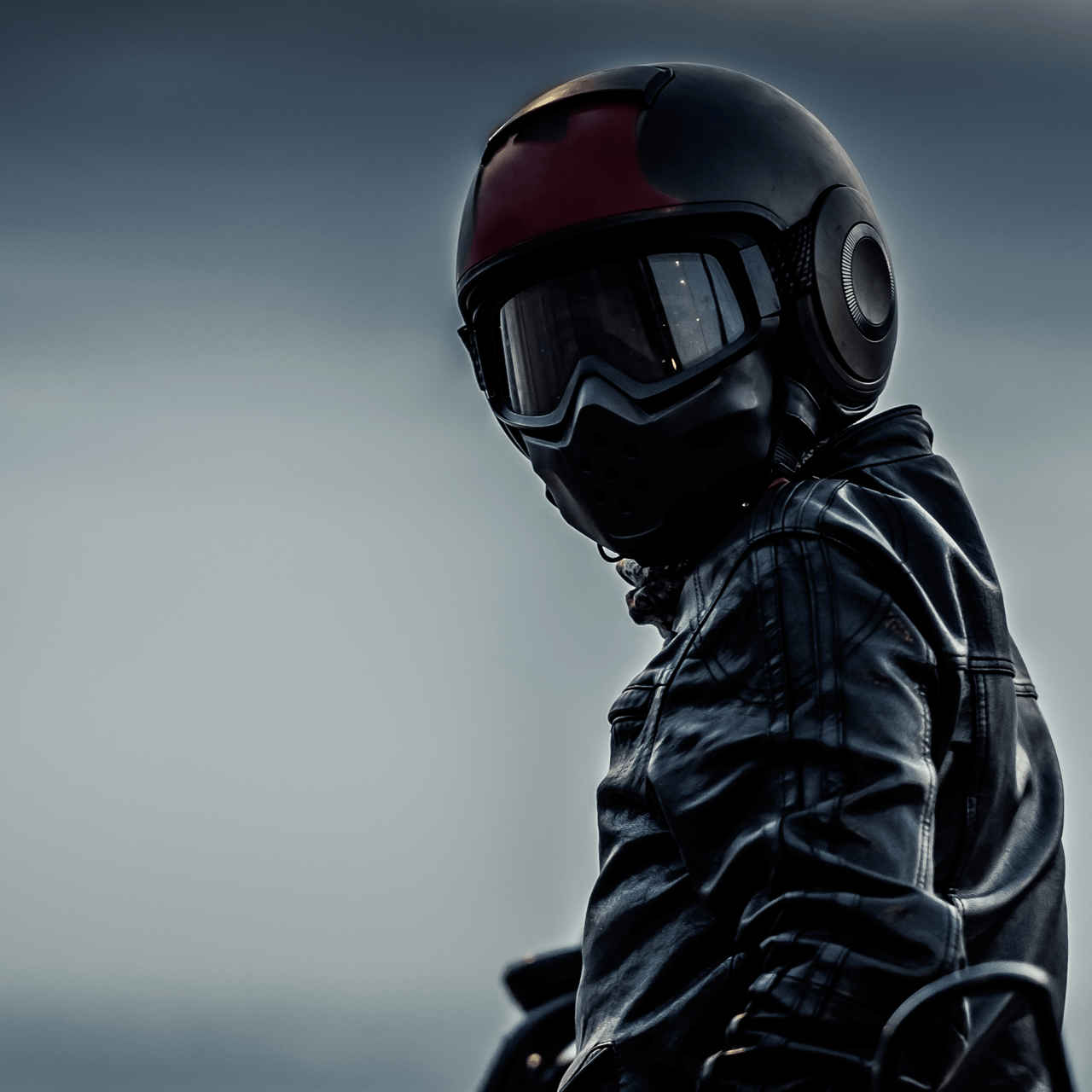 A biker donned all in black with black helmet